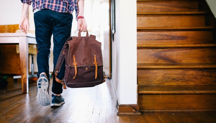 Person with back-pack walking.