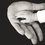 Child's hand in older person's hand